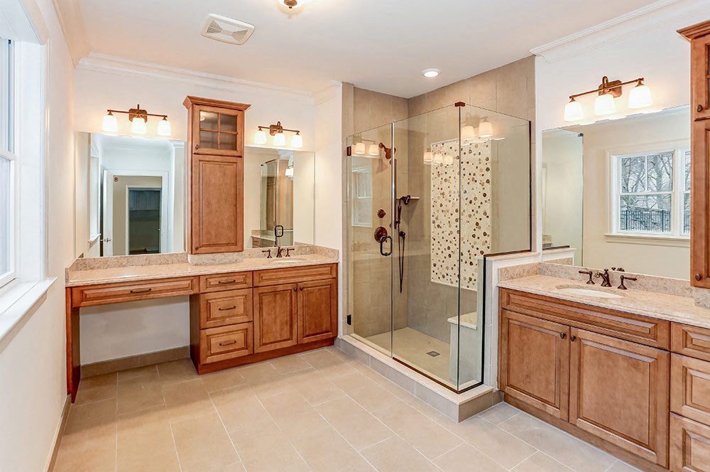 a large bathroom with two sinks and a shower