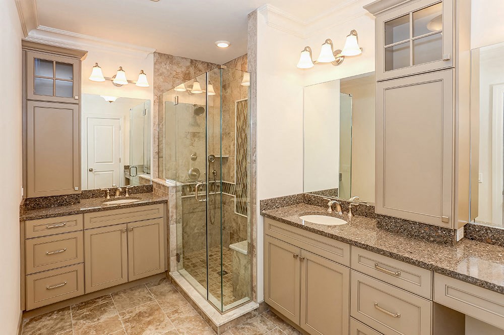 a bathroom with two sinks and a shower