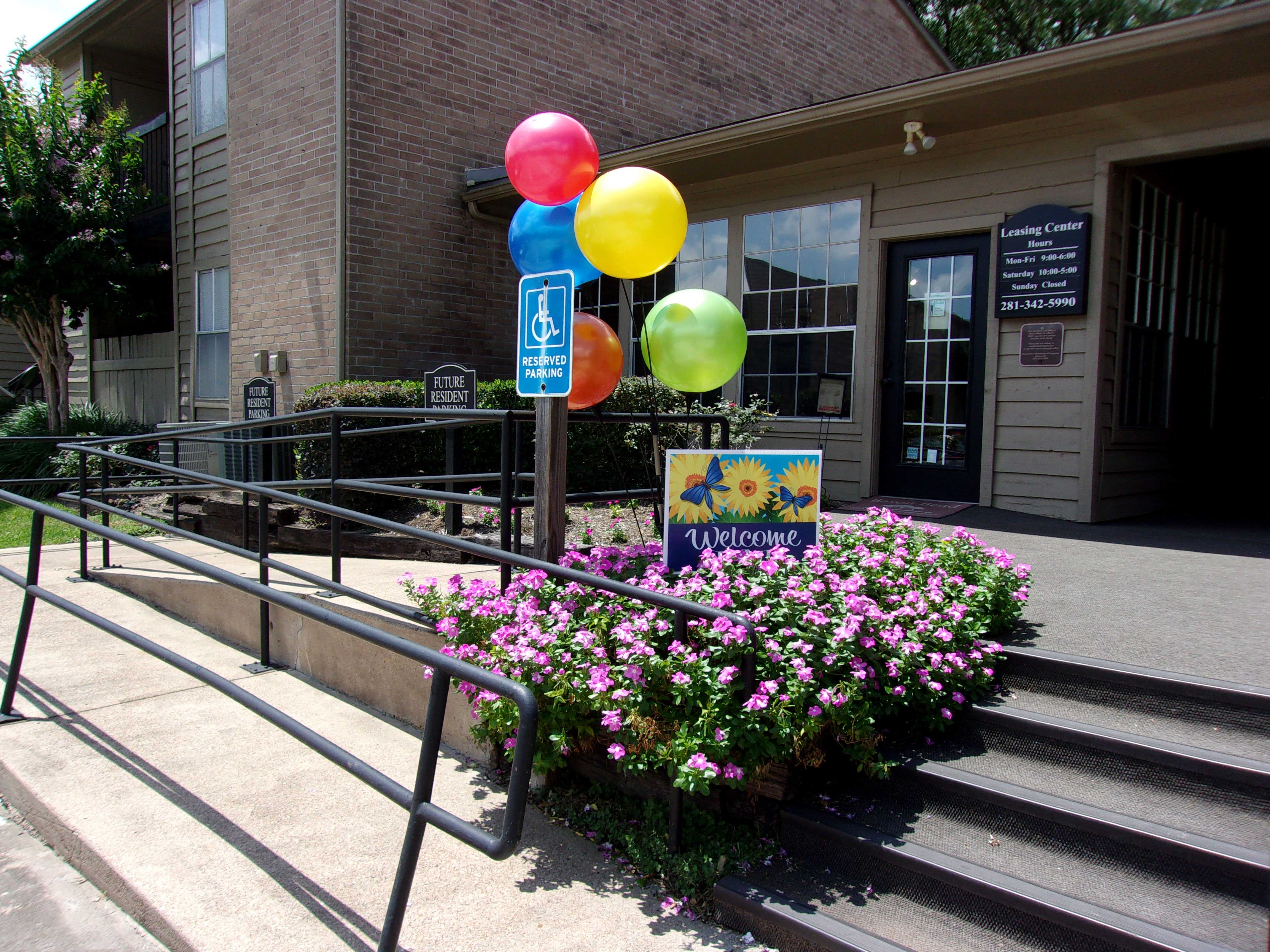 a building with flowers and balloons in front of it