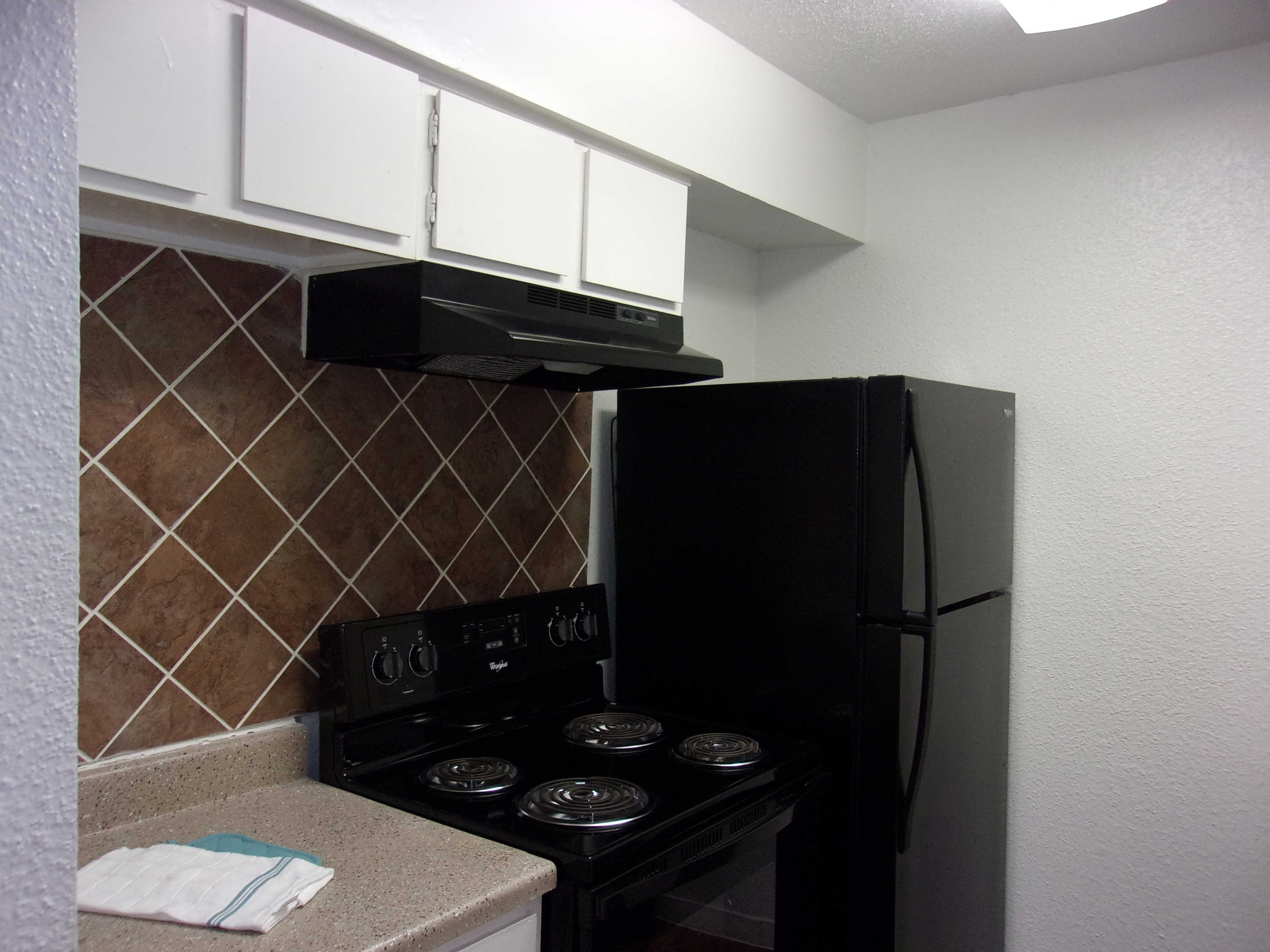 a kitchen with a stove and a refrigerator