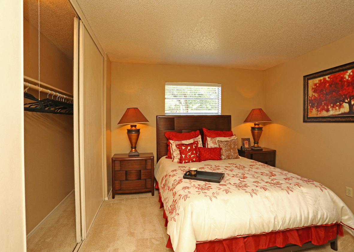 a bedroom with a bed and a closet