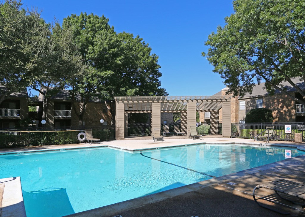 a swimming pool with a building in the background