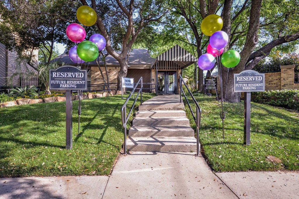 the entrance to the reserved parking lot with stairs and balloons