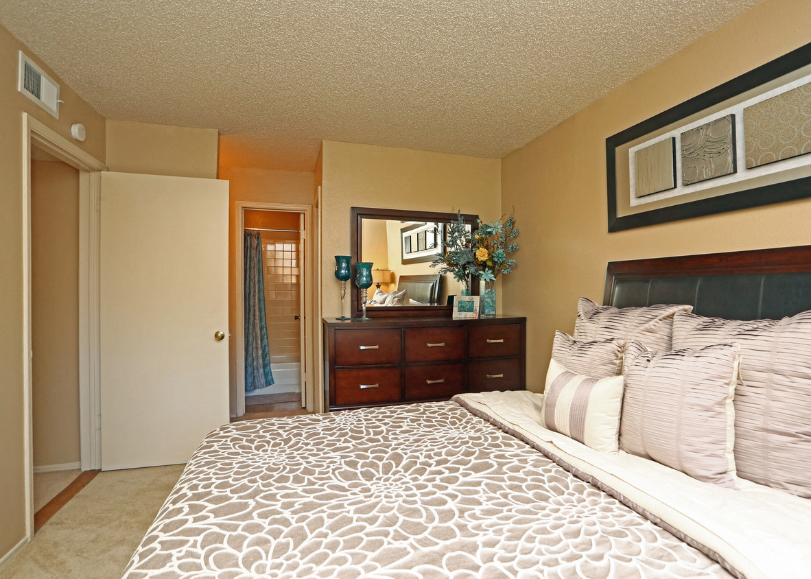 a bedroom with a large bed and a door to the bathroom