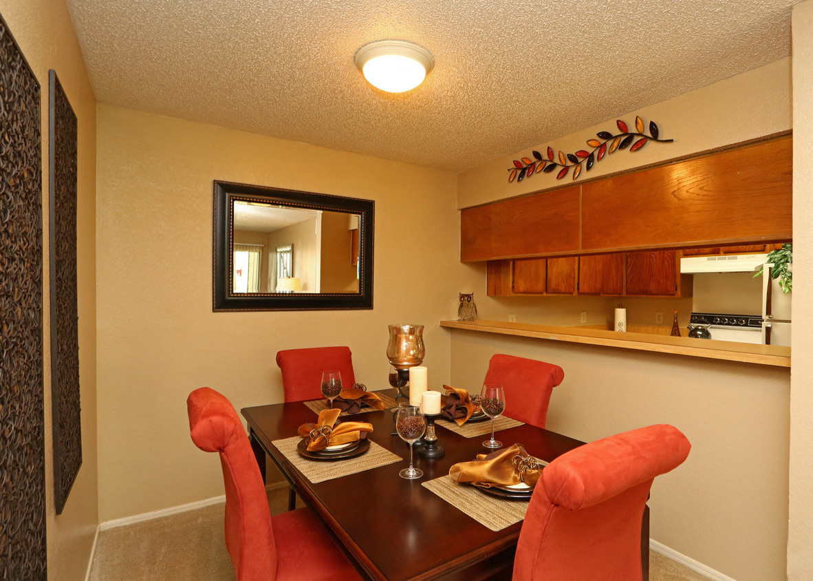 a dining room with a table and chairs