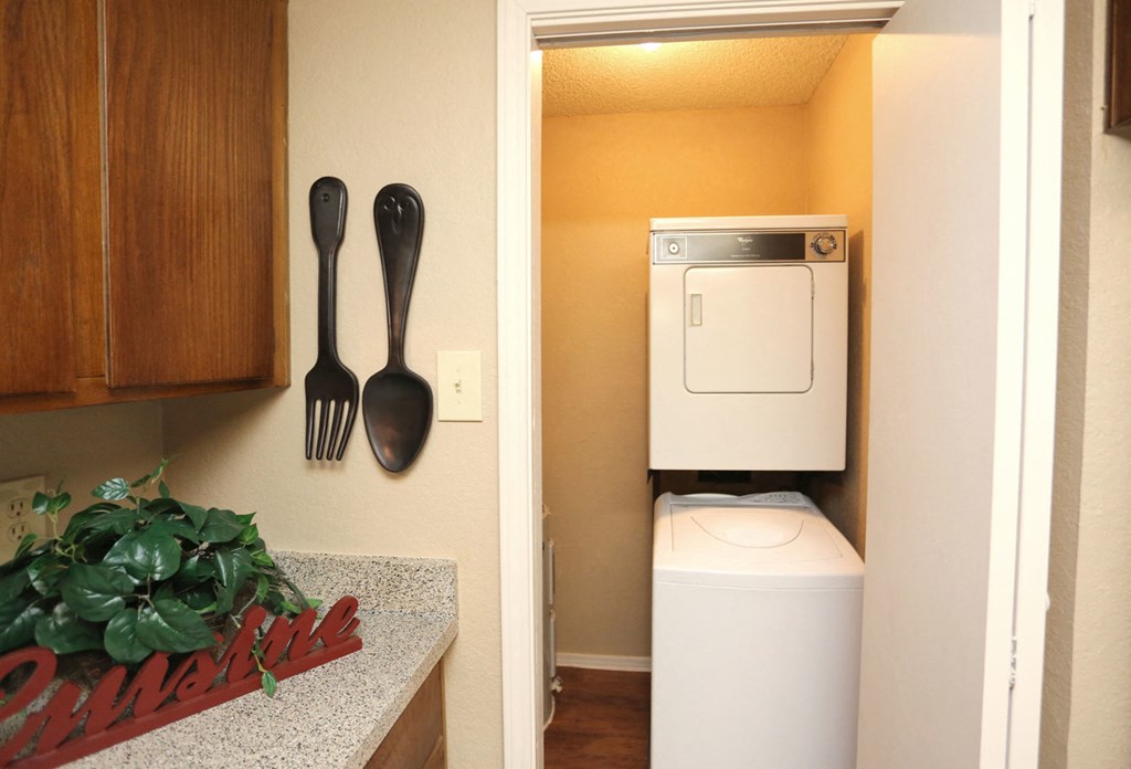 a small bathroom with a toilet and a sink and a washer and dryer