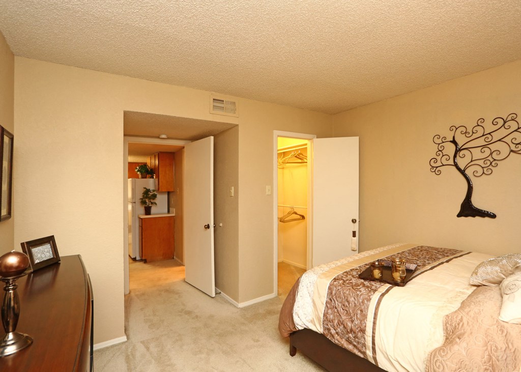 a bedroom with a large bed and a bathroom