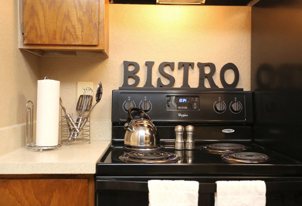 a bistro sign over a stove in a kitchen