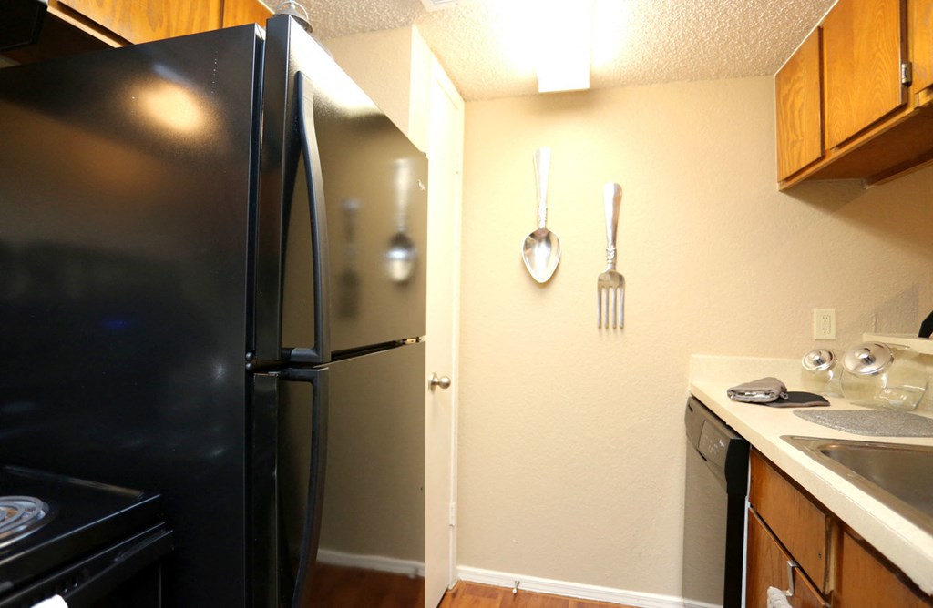 a kitchen with a refrigerator and a stove and a sink