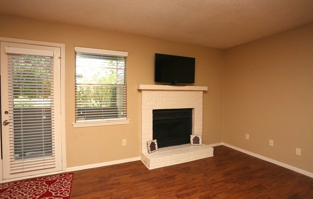 a living room with a fireplace and a tv on top of it