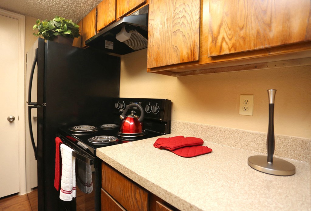 a kitchen with a stove and a kettle on the oven