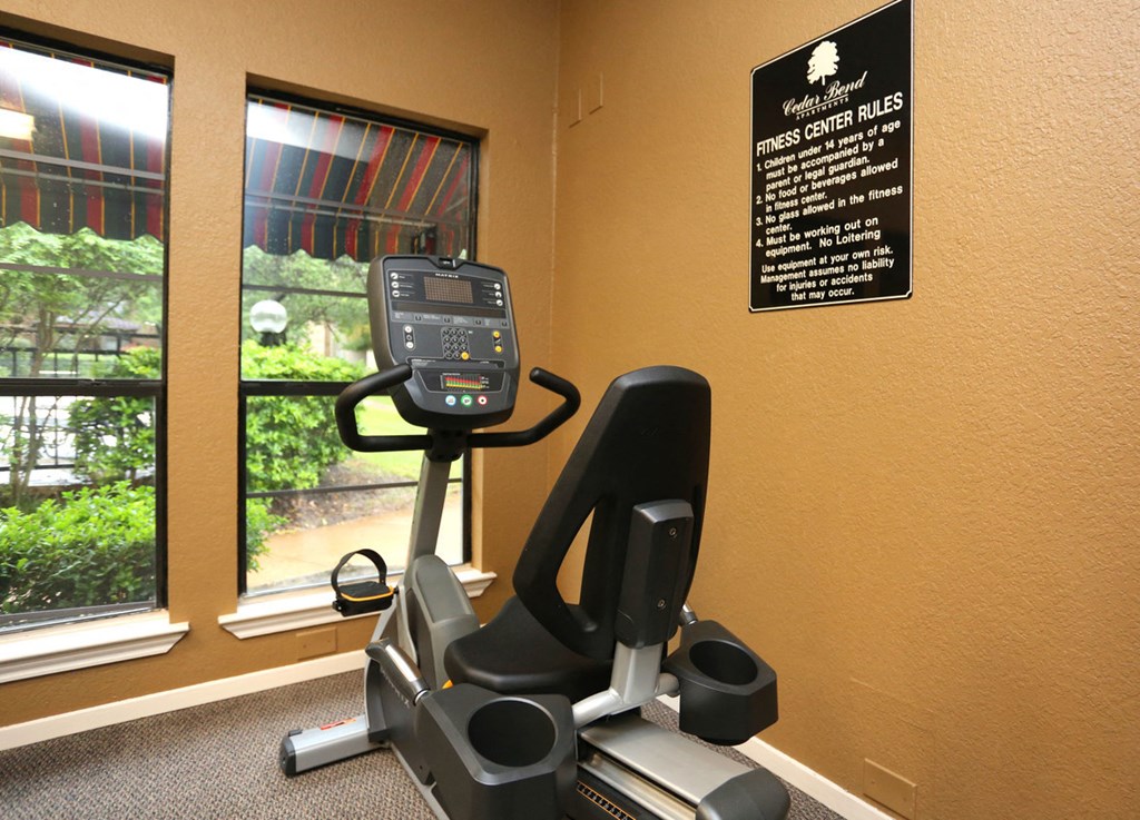 the gym is equipped with a treadmill and a large window