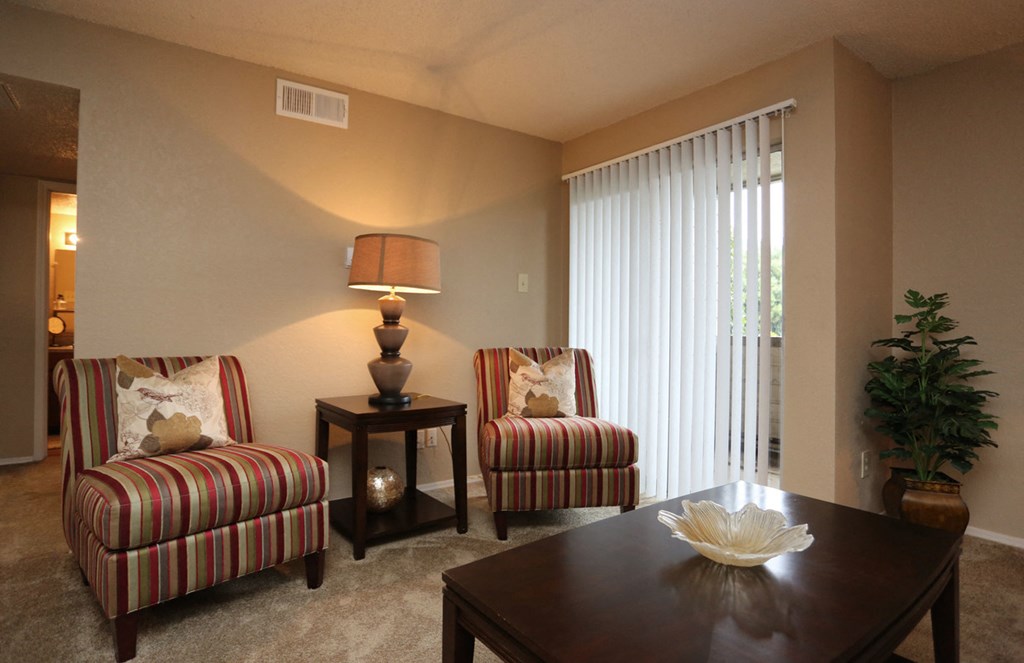 a living room with two chairs and a table