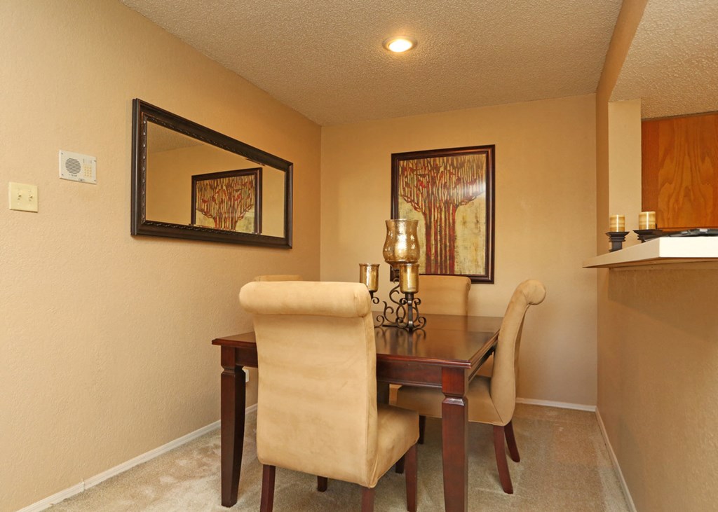 a dining room with a table and chairs