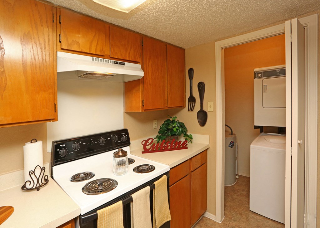 a kitchen with white appliances and wooden cabinets