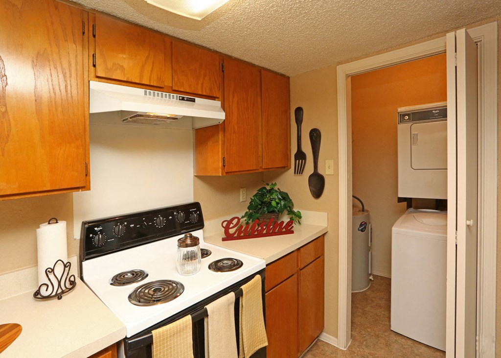 a kitchen with white appliances and wooden cabinets