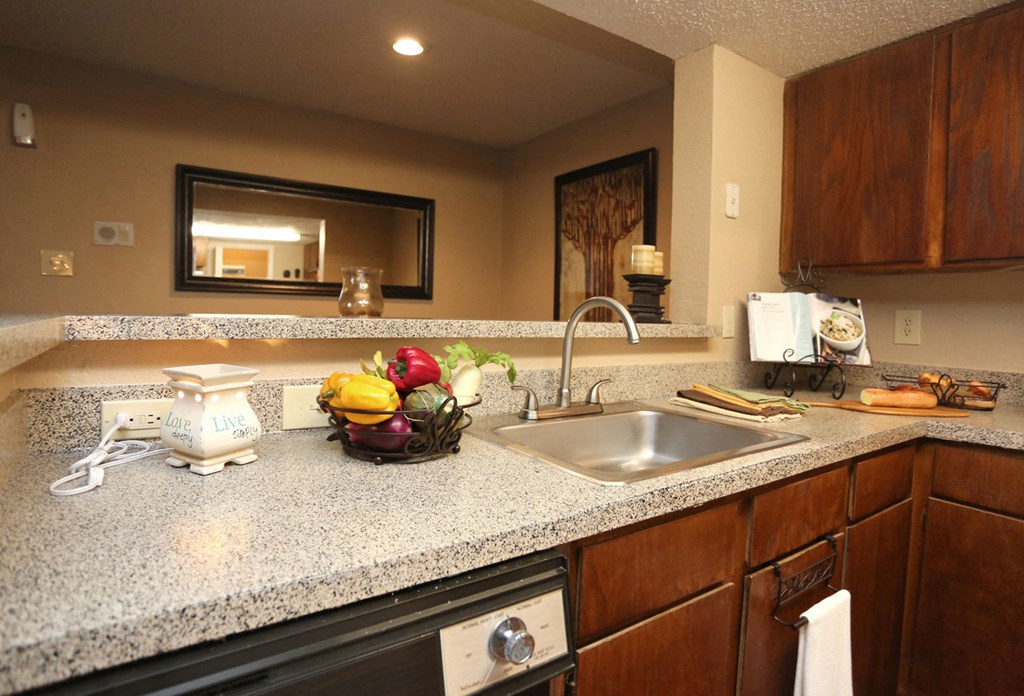 a kitchen with granite counter tops and a sink
