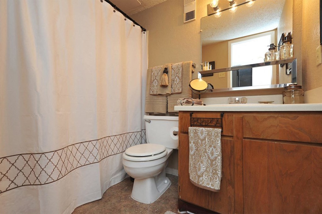 a bathroom with a toilet and a shower curtain
