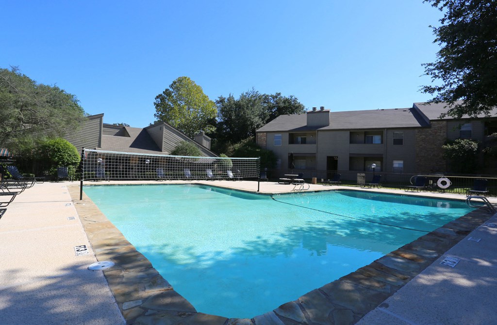 a swimming pool with a building in the background