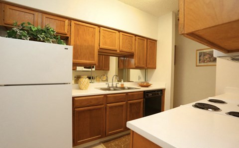 a kitchen with white appliances and wooden cabinets