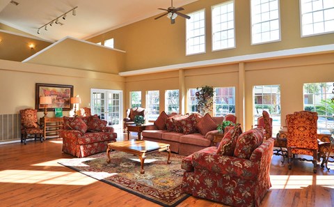 a large living room with furniture and windows