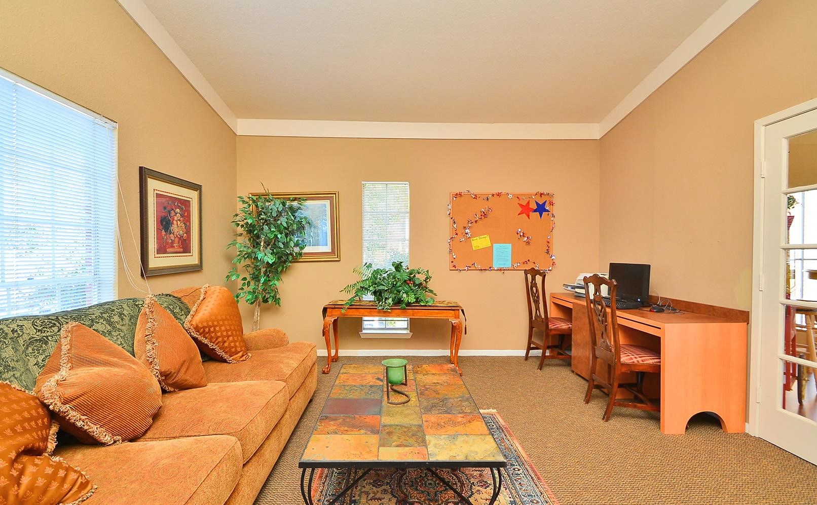 a living room with a couch and a desk