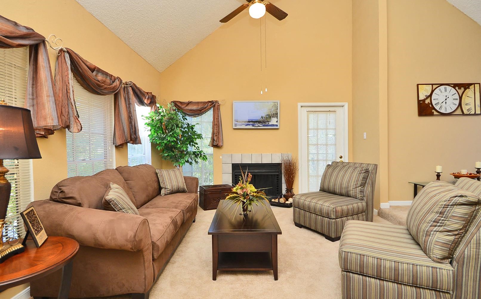 a living room with couches and chairs and a fireplace