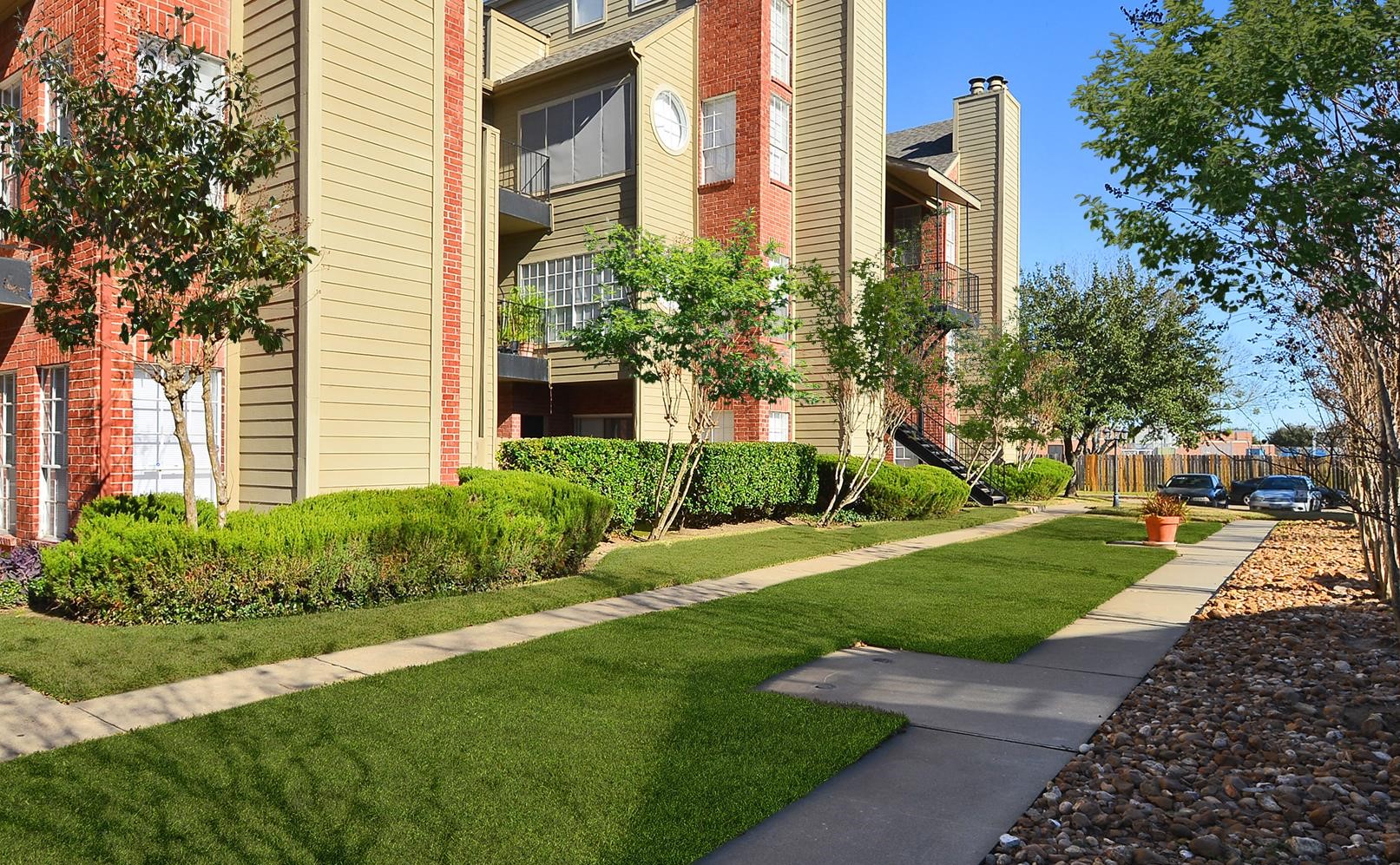 a sidewalk in front of an apartment building