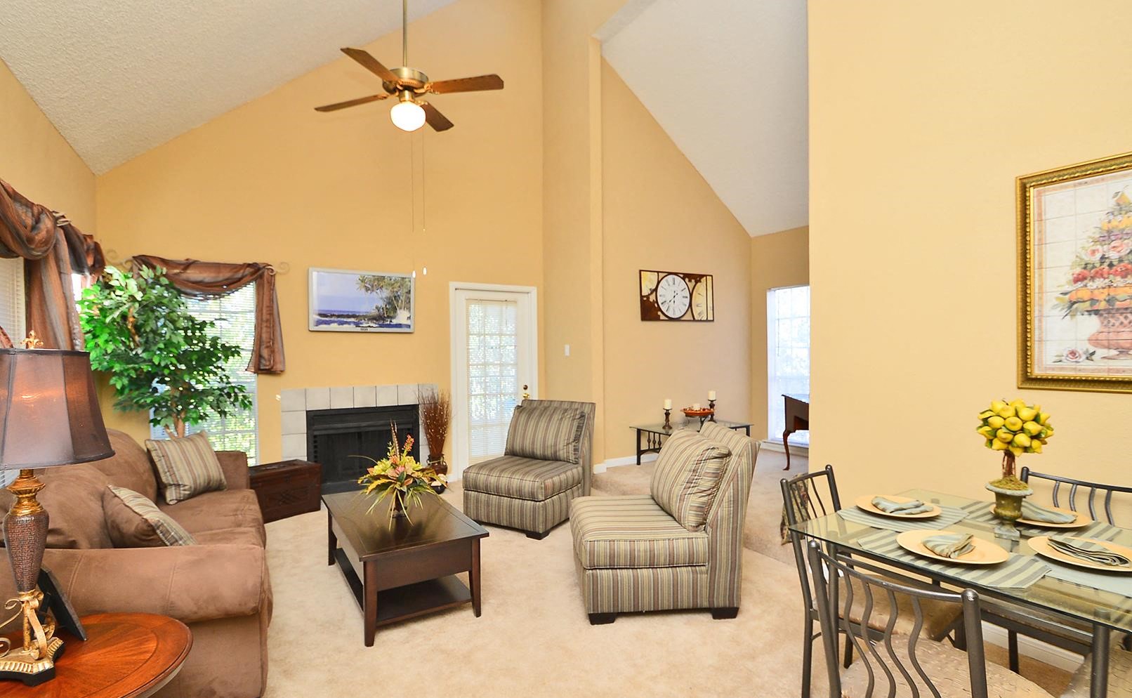 a living room with furniture and a ceiling fan