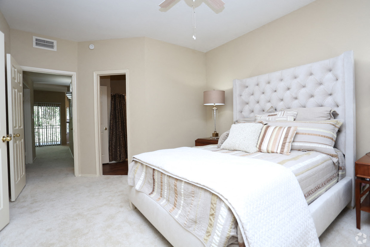 a bedroom with a large white bed and a closet