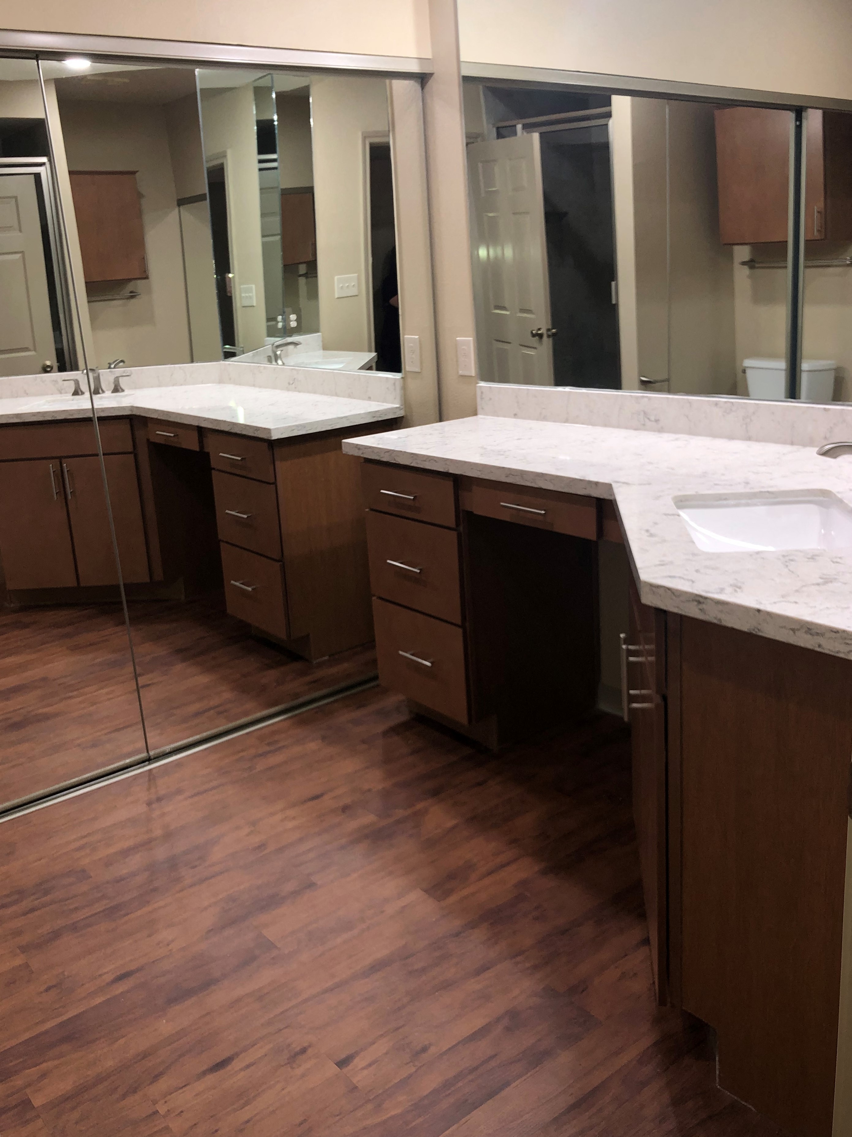 a bathroom with two sinks and a large mirror
