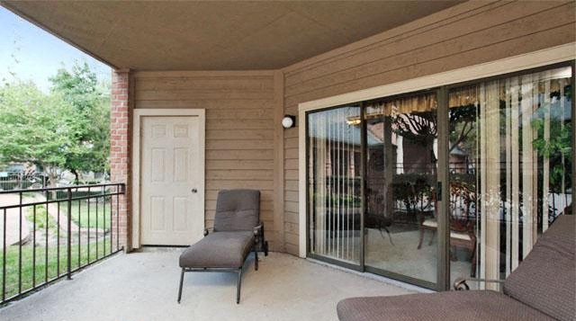 a room with a couch and a chair on a balcony