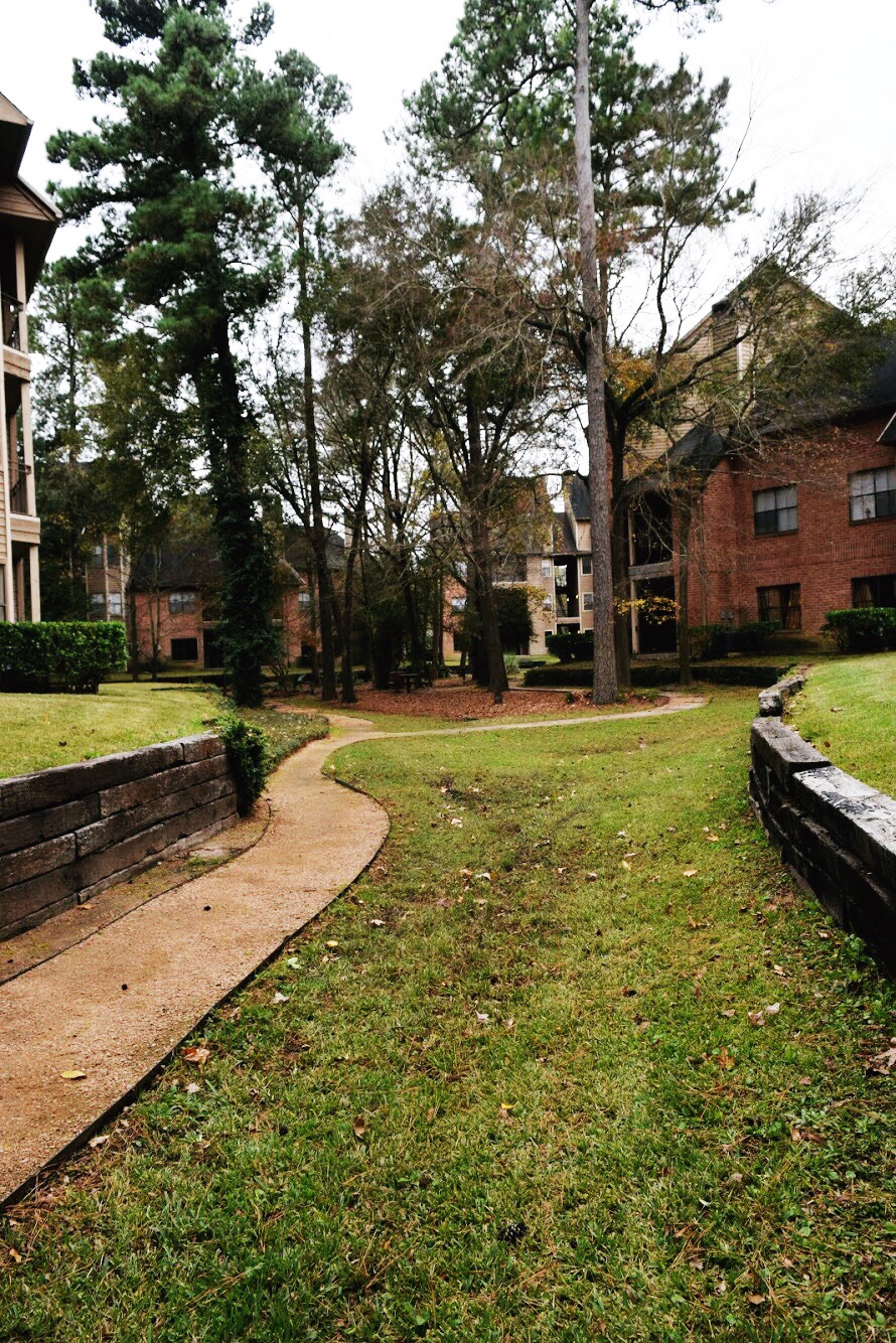 a walkway in front of a brick building
