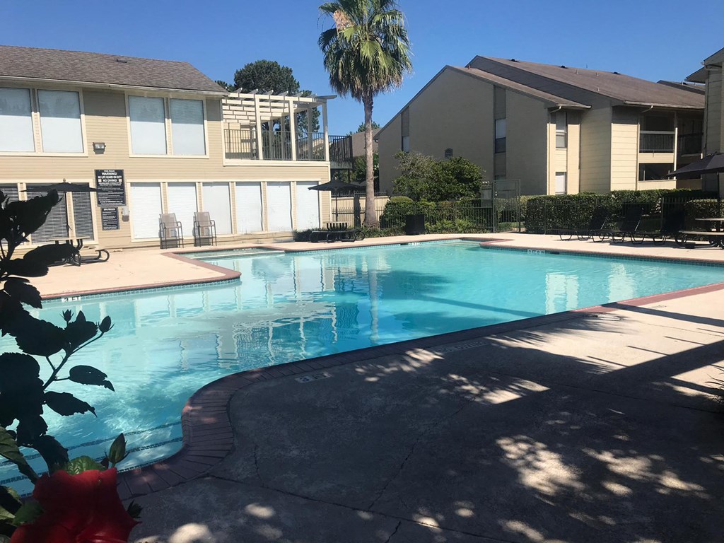 a swimming pool with a building in the background