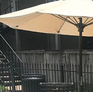 a patio with a table and chairs and an umbrella