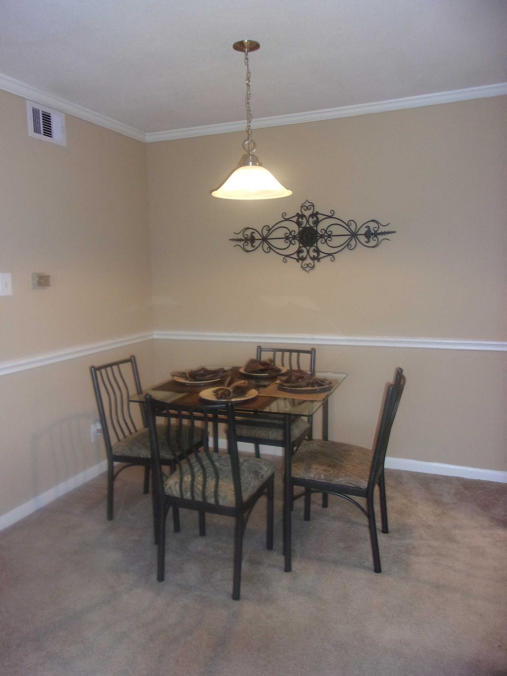an image of a dining room with a table and chairs