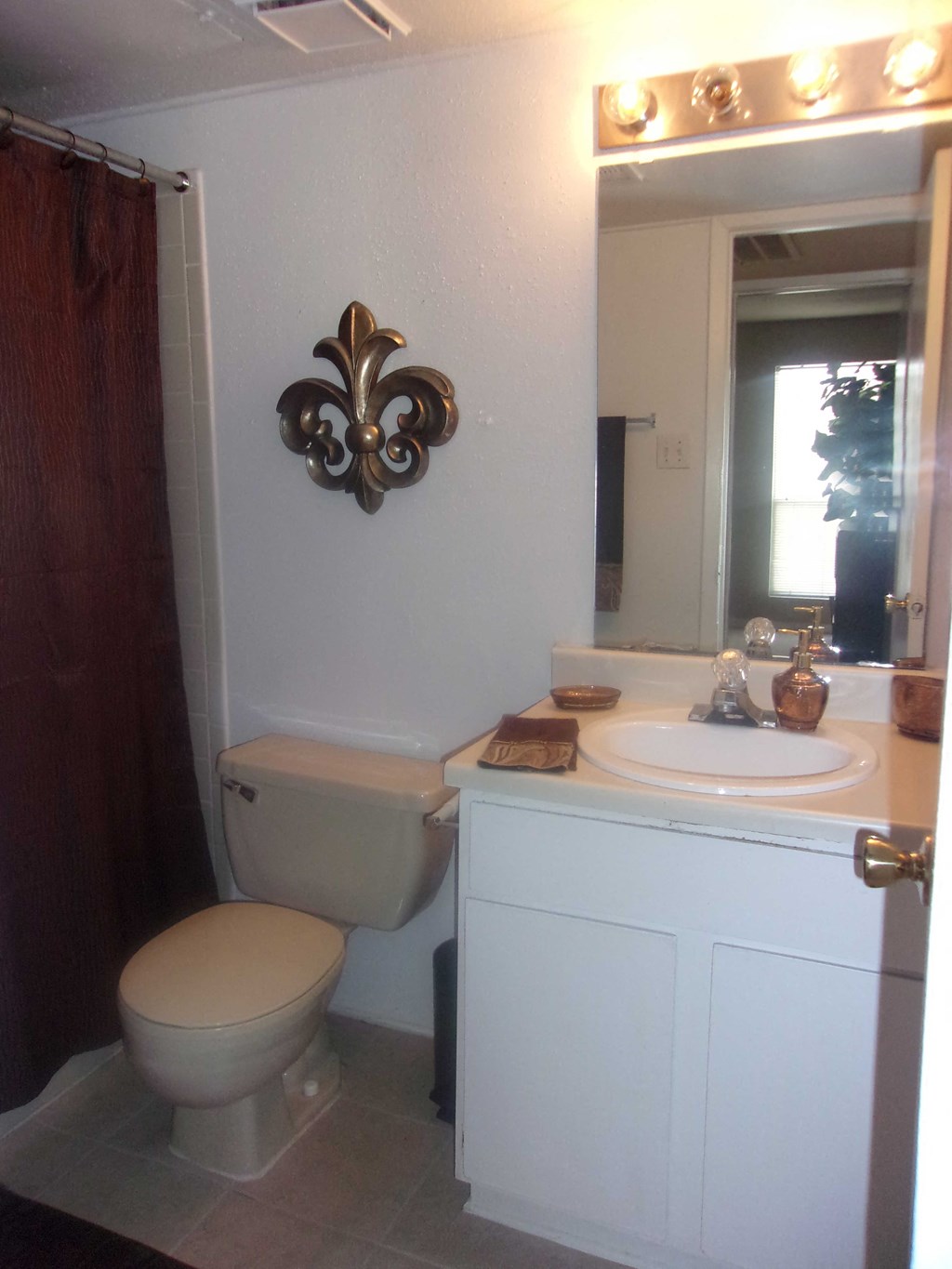 a bathroom with a toilet and a sink and a mirror
