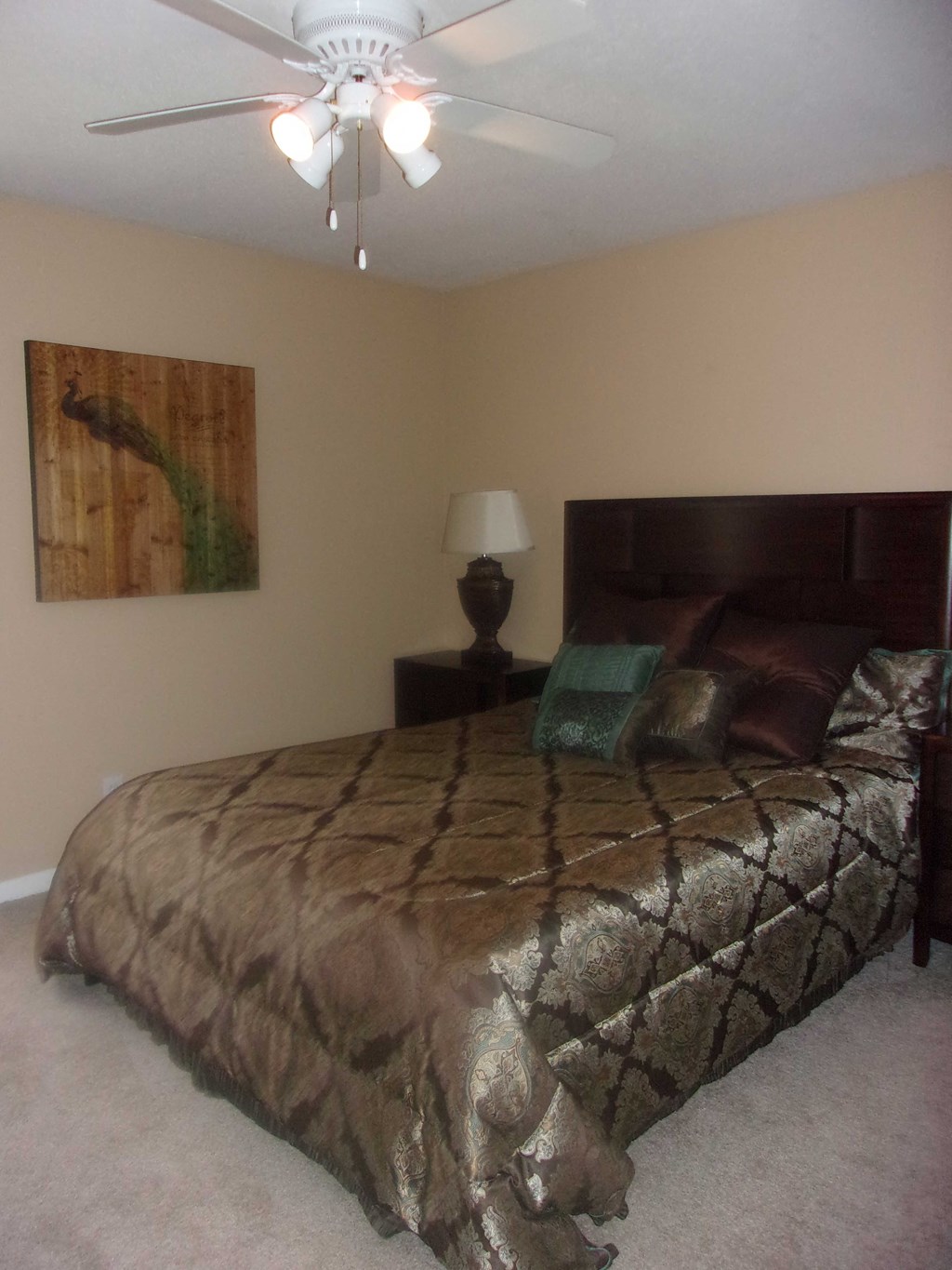 a bedroom with a bed and a ceiling fan