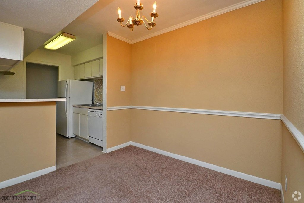 a dining room and kitchen with a carpet