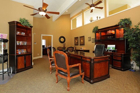 a home office with a desk and chairs