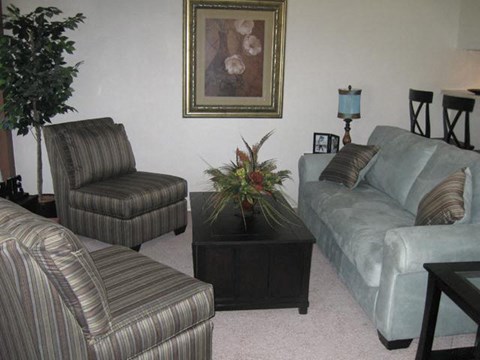a living room with couches and chairs and a table
