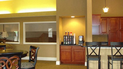 a living room with a dining room table and chairs