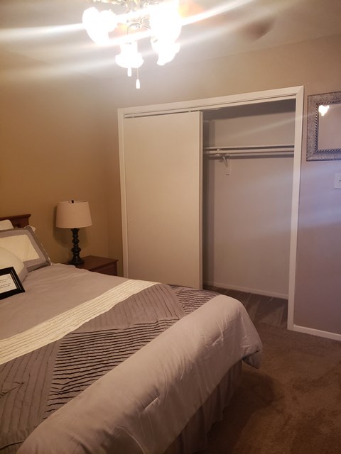 the master bedroom has a large closet and a bed