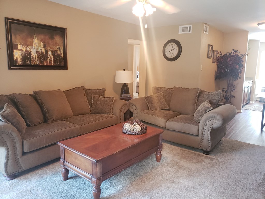 a living room with couches and a coffee table