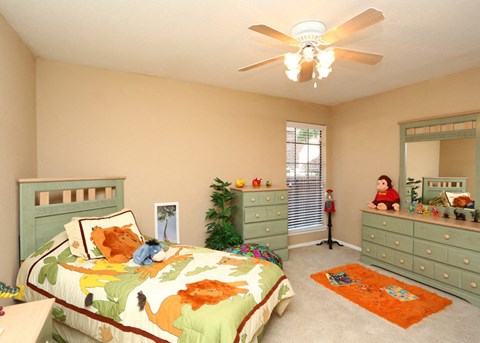 a bedroom with a bed and a ceiling fan