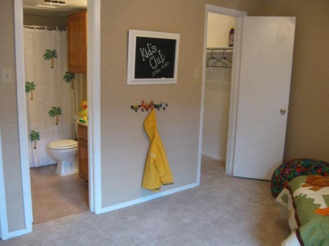 a bathroom with a yellow towel hanging on the wall