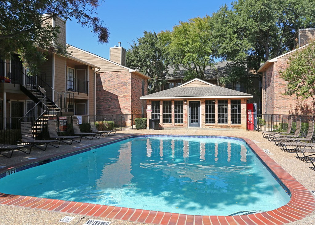 a swimming pool in front of an apartment building