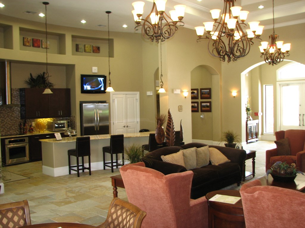 an open living room and kitchen with couches and chairs