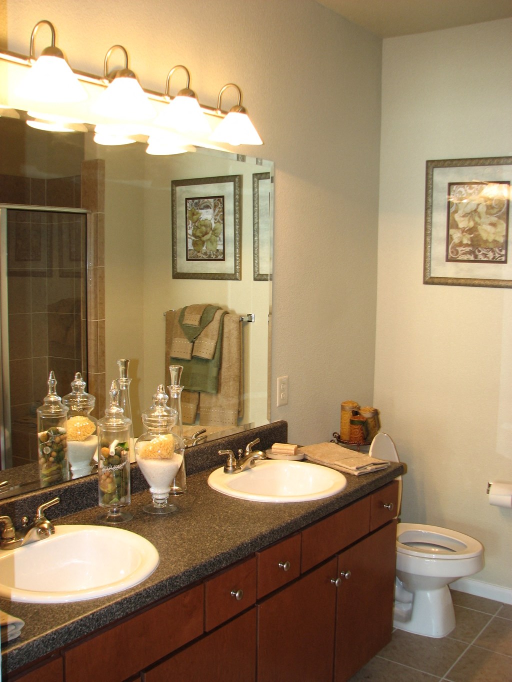 a bathroom with two sinks and a mirror and a toilet