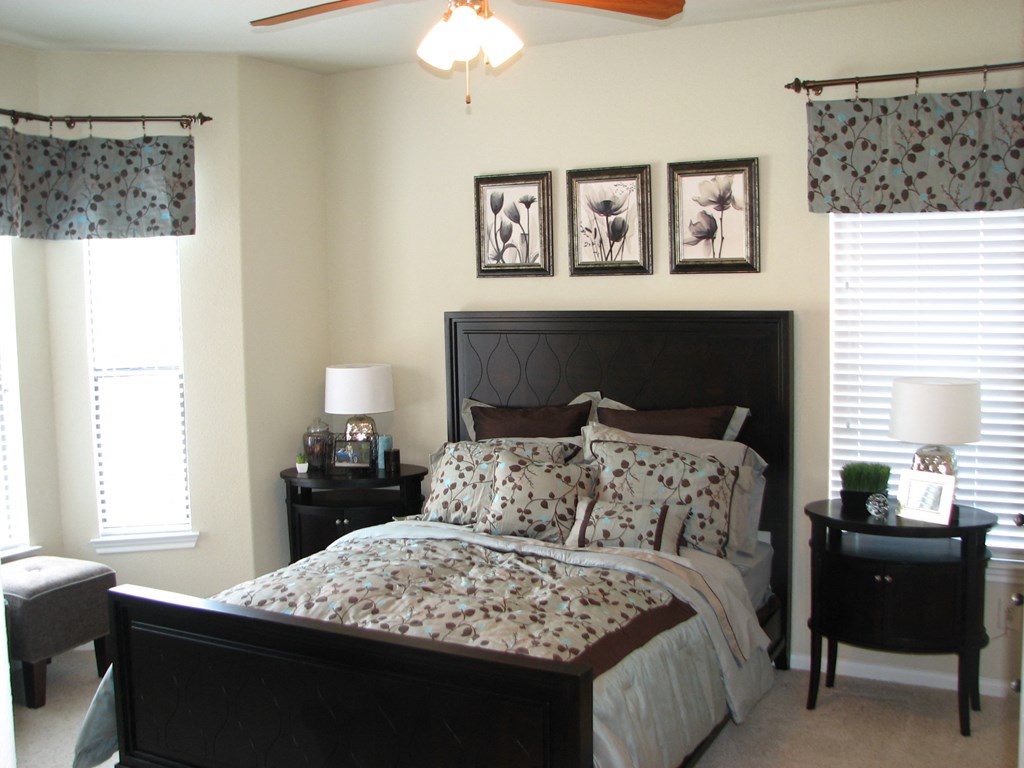 a bedroom with a bed and some pictures on the wall